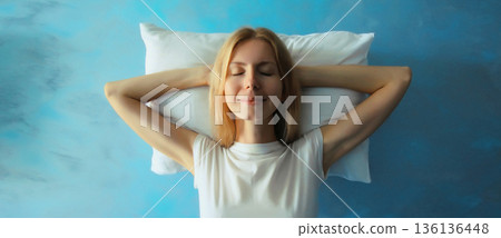 Healthy sleep, happy relaxed sleepy young woman lying on white soft comfortable pillow Healthy sleep, happy relaxed sleepy young woman lying on white soft comfortable pillow 136136448