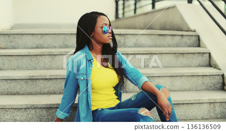 stylish young african woman posing in the city stylish young african woman posing in the city 136136509