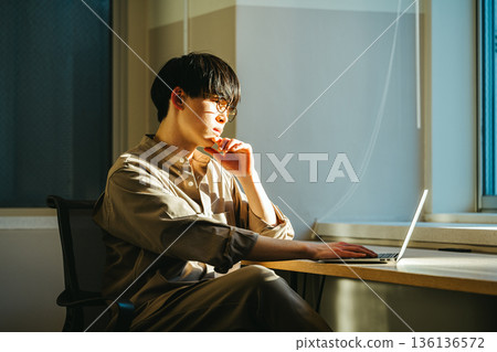 A young man thinking at dusk A young man thinking at dusk 136136572