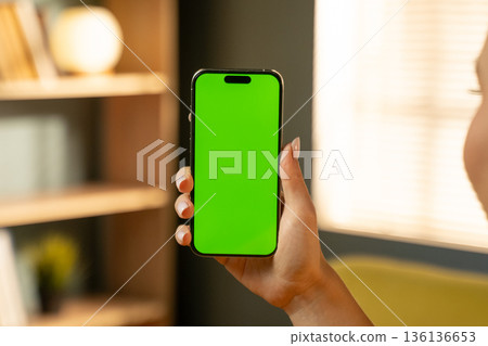 Person holding a mobile phone with a chroma key green screen, suitable for displaying various apps, videos, or messages, highlighting concepts of technology, connectivity, and communication Person holding a mobile phone with a chroma key green screen, suitable for displaying various apps, videos, or messages, highlighting concepts of technology, connectivity, and communication 136136653