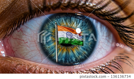 A detailed macro shot captures a human eye with a vibrant Indian flag reflected in its blue-green iris, symbolizing patriotism, national pride, and a global Indian perspective. 136136734