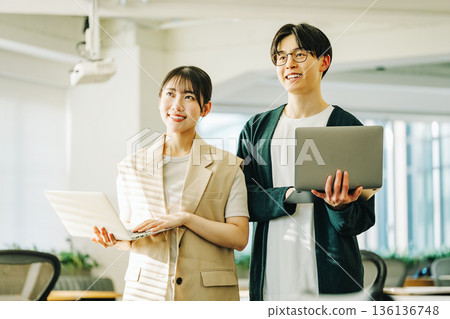 Young IT engineer man and woman with laptop 136136748