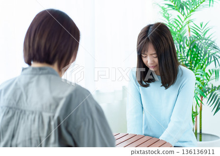 A woman apologizing after being scolded, power harassment, moral harassment A woman apologizing after being scolded, power harassment, moral harassment 136136911