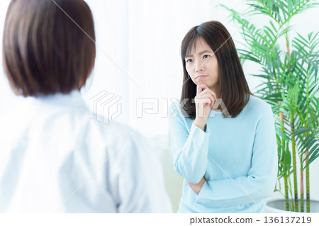 Woman worried about doctor's diagnosis Woman worried about doctor's diagnosis 136137219