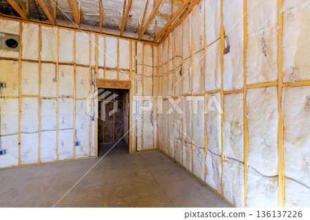 Construction reveals walls with insulation in developing building 136137226