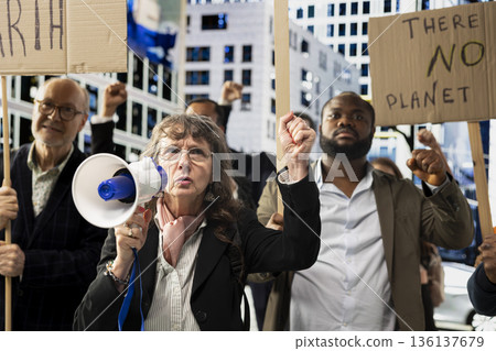 Multiethnic protesters and demonstrators gather in environmental rally, showing unity and community while protesting global crisis and warming. Signs focused on clean environment. Multiethnic protesters and demonstrators gather in environmental rally, showing unity and community while protesting global crisis and warming. Signs focused on clean environment. 136137679