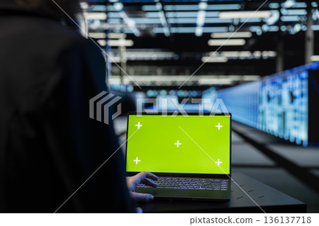 Isolated screen laptop used by technician in data center verifying firewall settings. Server hub worker using mockup notebook to perform equipment rigs vulnerability scans in server farm, close up 136137718