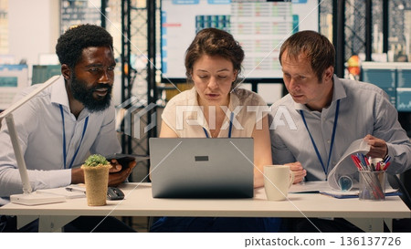 Diverse corporate team, action plan, business briefing objectives. Data analysis, KPI dashboard and reports, modern office environment, risk assessment, organizational agenda. Diverse corporate team, action plan, business briefing objectives. Data analysis, KPI dashboard and reports, modern office environment, risk assessment, organizational agenda. 136137726
