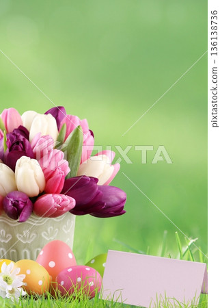 Easter eggs and colorful tulips in green grass with copy space Easter eggs and colorful tulips in green grass with copy space 136138736
