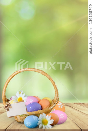 Easter basket displaying colorful decorated eggs and flowers 136138749