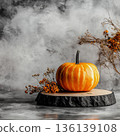 Rustic Pumpkin Still Life on Wood Slice with Autumn Branches and Moody Fall Background Copy Space 136139108