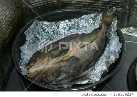 Atka mackerel fillet being cooked in a frying pan 136139224
