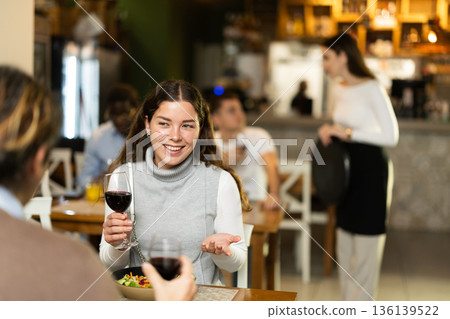 Woman talking to her husband in a restaurant 136139522