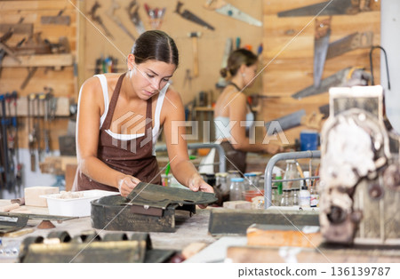 Girl is busy in carpentry workshop 136139787