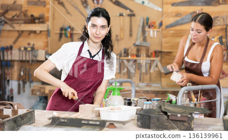 Girl working with wood in carpentry workshop Girl working with wood in carpentry workshop 136139961