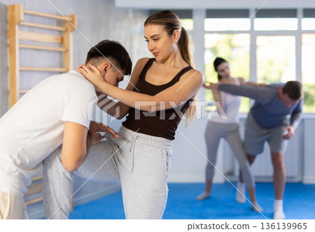 Self defense lesson - woman learns to fight back an attacking man 136139965
