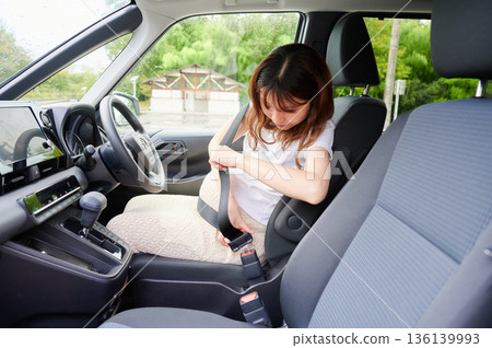 Driving woman, pregnant woman, child Driving woman, pregnant woman, child 136139993