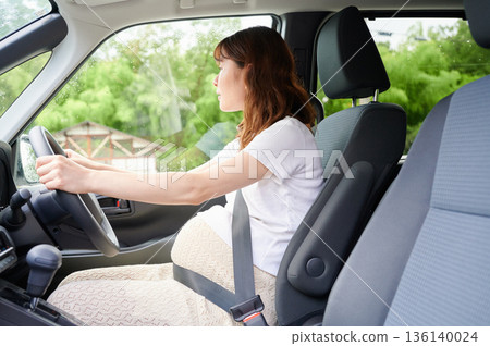 Driving woman, pregnant woman, child Driving woman, pregnant woman, child 136140024