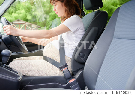 Driving woman, pregnant woman, child 136140035