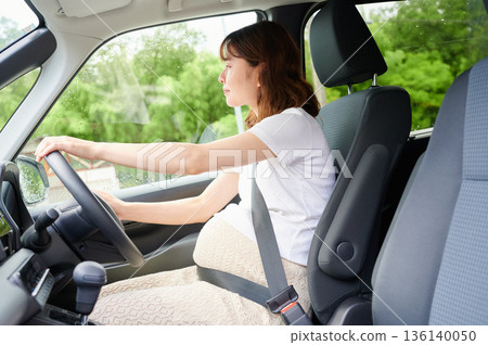 Driving woman, pregnant woman, child Driving woman, pregnant woman, child 136140050