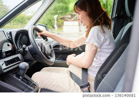 Driving woman, pregnant woman, child Driving woman, pregnant woman, child 136140081