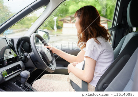 Driving woman, pregnant woman, child Driving woman, pregnant woman, child 136140083
