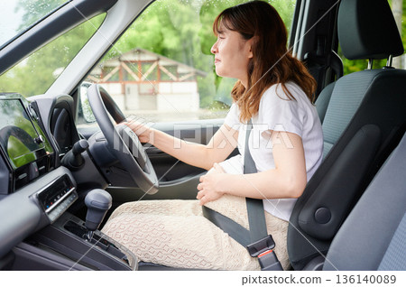 Driving woman, pregnant woman, child Driving woman, pregnant woman, child 136140089
