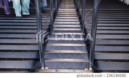 Modern staircase with green lights and silhouetted parent and child climbing Modern staircase with green lights and silhouetted parent and child climbing 136140090