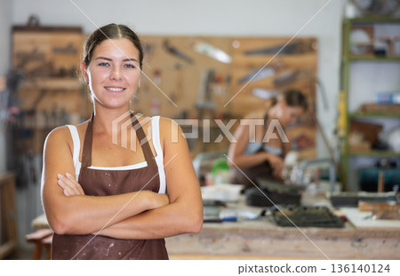 Girl is busy in carpentry workshop 136140124
