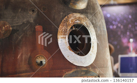 Space capsule module showing reentry burn damage with exposed portal 136140157