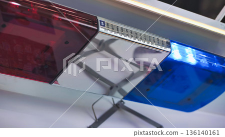 Police emergency light bar flashing red and blue, symbolizing law and order 136140161