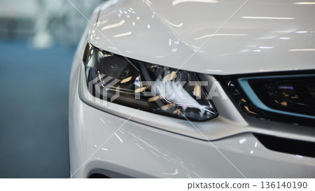 White car headlight close up showing modern vehicle design and technology White car headlight close up showing modern vehicle design and technology 136140190