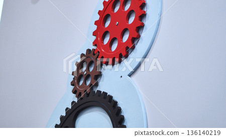 Interlocking gears demonstrating teamwork and industry concept at an exhibition 136140219