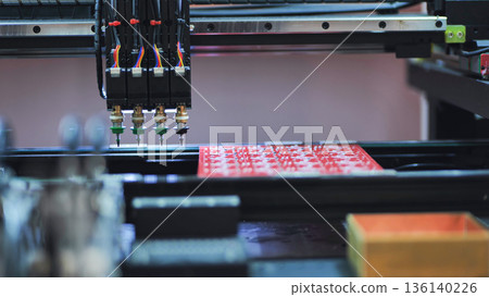Pick and place robot machine assembling electronic circuit boards in factory Pick and place robot machine assembling electronic circuit boards in factory 136140226