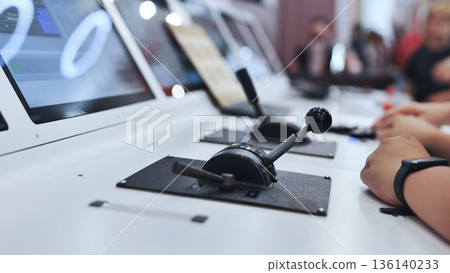 Person operating power levers in a modern flight simulator control panel 136140233