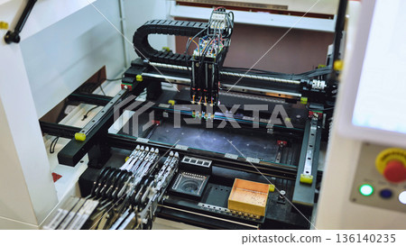 Pick and place machine assembling electronic components in SMT manufacturing facility 136140235