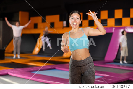 Young woman posing on workout in trampoline center 136140237