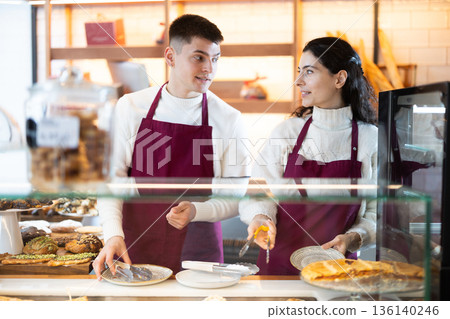 Young woman and man at cafe window Young woman and man at cafe window 136140246