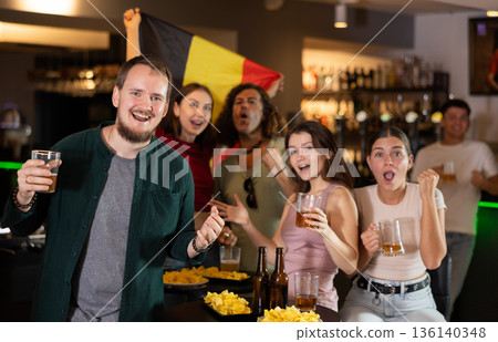 Group of fans in bar with Belgian flag Group of fans in bar with Belgian flag 136140348