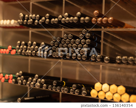 Art and stationery store displaying numerous colored pencils on organized shelves 136140354