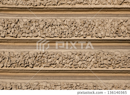 Beige wall texture with horizontal rough stone and concrete stripes pattern Beige wall texture with horizontal rough stone and concrete stripes pattern 136140365