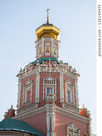 Epiphany Cathedral tower with gilded dome and pink baroque facade in Moscow 136140435