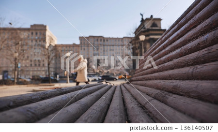 Wooden bench inviting to sit and relax in Moscow city center Wooden bench inviting to sit and relax in Moscow city center 136140507