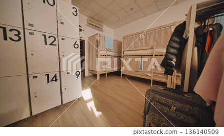 Hostel dormitory with bunk beds and lockers for budget travel accommodation 136140509