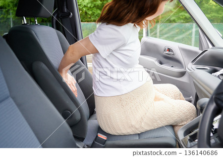 Driving woman, pregnant woman, child Driving woman, pregnant woman, child 136140686