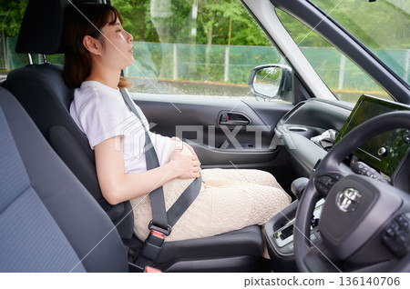 Driving woman, pregnant woman, child Driving woman, pregnant woman, child 136140706