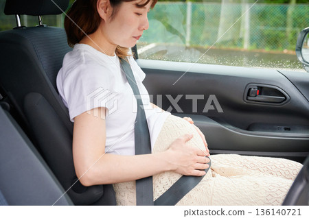 Driving woman, pregnant woman, child Driving woman, pregnant woman, child 136140721