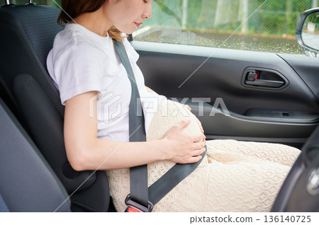 Driving woman, pregnant woman, child Driving woman, pregnant woman, child 136140725