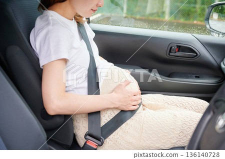 Driving woman, pregnant woman, child Driving woman, pregnant woman, child 136140728
