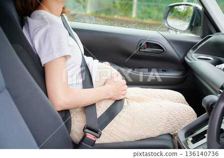 Driving woman, pregnant woman, child Driving woman, pregnant woman, child 136140736